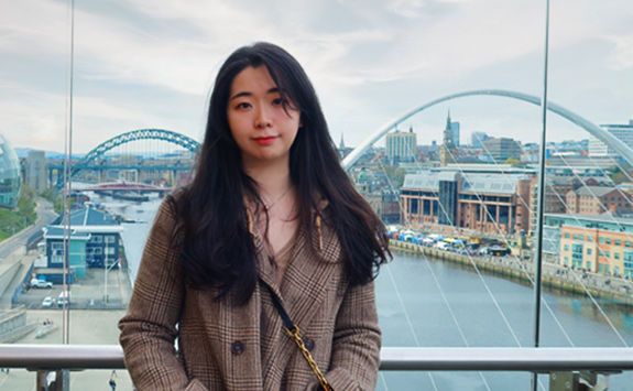 NUBS PGR student Yudian Chen with Newcastle Quayside and bridges in the background